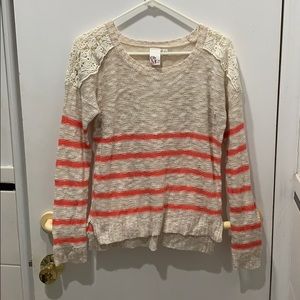 A striped sweater with lace detail